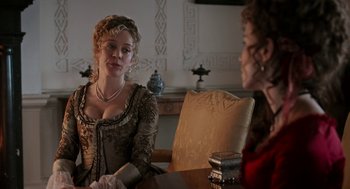 Movie still from “Love & Friendship” (2016), directed by Whit Stillman – Two women sitting at a table talking to each other; Medium shot, Over the shoulder angle