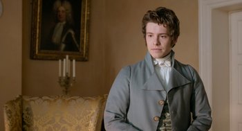 Movie still from “Love & Friendship” (2016), directed by Whit Stillman – A young man in a victorian era suit; Medium shot, Over the shoulder angle