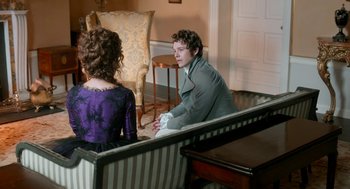 Movie still from “Love & Friendship” (2016), directed by Whit Stillman – A man and a woman sitting on a couch in a living room; Medium shot, High angle