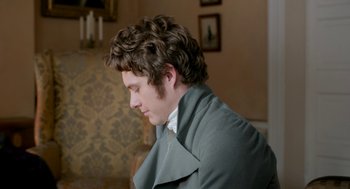 Movie still from “Love & Friendship” (2016), directed by Whit Stillman – A young man in a gray coat is looking down; Close Up shot, High angle