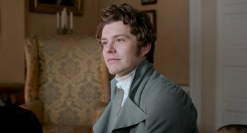 Movie still from “Love & Friendship” (2016), directed by Whit Stillman – A man in a gray coat is looking at the camera; Close Up shot, High angle
