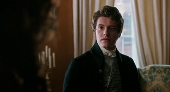 Movie still from “Love & Friendship” (2016), directed by Whit Stillman – A man in a suit and a white shirt; Close Up shot, Over the shoulder angle