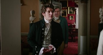 Movie still from “Love & Friendship” (2016), directed by Whit Stillman – A man in a green jacket standing next to another man in a black jacket; Medium shot, Over the shoulder angle