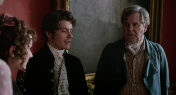 Movie still from “Love & Friendship” (2016), directed by Whit Stillman – A man and an older man standing next to each other; Medium shot, Over the shoulder angle
