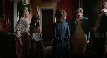 Movie still from “Love & Friendship” (2016), directed by Whit Stillman – A group of people standing in a room; Medium shot, Over the shoulder angle
