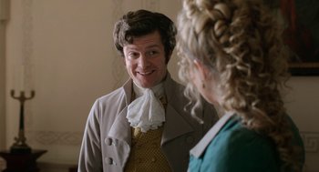 Movie still from “Love & Friendship” (2016), directed by Whit Stillman – A man and a woman are looking at each other in the mirror; Close Up shot, Over the shoulder angle