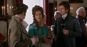 Movie still from “Love & Friendship” (2016), directed by Whit Stillman – A group of people standing next to each other holding wine glasses; Medium shot, Over the shoulder angle