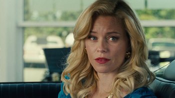 Movie still from “Love & Mercy” (2014), directed by Bill Pohlad – A woman with blonde curly hair sitting in front of a window; Close Up shot, Over the shoulder angle