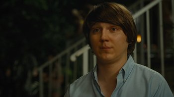 Movie still from “Love & Mercy” (2014), directed by Bill Pohlad – A young man with long brown hair wearing a light blue shirt; Close Up shot, Over the shoulder angle