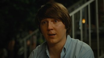 Movie still from “Love & Mercy” (2014), directed by Bill Pohlad – A young man with long brown hair wearing a light blue shirt; Close Up shot, Over the shoulder angle
