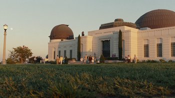 Movie still from “Love & Mercy” (2014), directed by Bill Pohlad – A group of people standing in front of a large building; Extreme Wide shot, Low angle