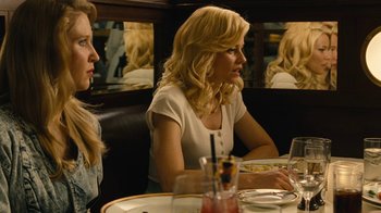 Movie still from “Love & Mercy” (2014), directed by Bill Pohlad – Two women sitting at a table in front of each other; Medium shot, Over the shoulder angle