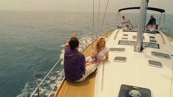 Movie still from “Love & Mercy” (2014), directed by Bill Pohlad – A man and a woman sitting on the deck of a sailboat; Wide shot, High angle