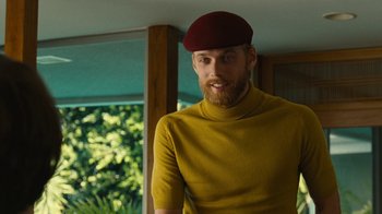Movie still from “Love & Mercy” (2014), directed by Bill Pohlad – A man with a beard wearing a yellow shirt and a red hat; Medium shot, Low angle