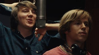 Movie still from “Love & Mercy” (2014), directed by Bill Pohlad – Two young men in a recording studio with a microphone; Close Up shot, Low angle