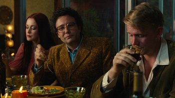 Movie still from “Love & Mercy” (2014), directed by Bill Pohlad – Two men sitting at a table with a plate of food; Medium shot, Over the shoulder angle