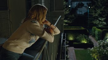 Movie still from “Love & Mercy” (2014), directed by Bill Pohlad – A woman leaning on a railing at night; Medium shot, High angle