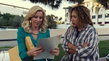 Movie still from “Love & Mercy” (2014), directed by Bill Pohlad – Two women are looking at a piece of paper; Medium shot, Over the shoulder angle