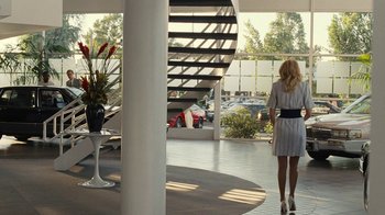 Movie still from “Love & Mercy” (2014), directed by Bill Pohlad – A woman in a dress walking down a staircase; Wide shot, Over the shoulder angle