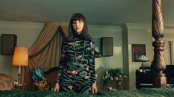 Movie still from “Love & Mercy” (2014), directed by Bill Pohlad – A woman standing in front of a bed in a living room; Medium shot, High angle