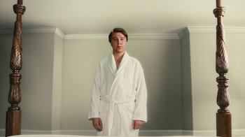Movie still from “Love & Mercy” (2014), directed by Bill Pohlad – A man in a white bathrobe standing in a room; Medium shot, Low angle