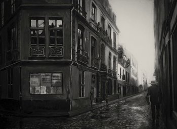A black - and - white photo of a street with buildings