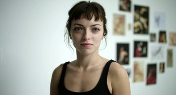 Movie still from “M.F.A.” (2017), directed by Natalia Leite – A person wearing a tank top; Close Up shot, Low angle