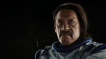 Movie still from “Machete Kills” (2013), directed by Robert Rodriguez – An old man with long black hair and a mustache; Close Up shot, Low angle