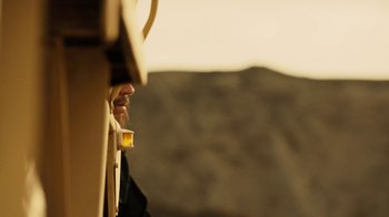 Movie still from “Machete Kills” (2013), directed by Robert Rodriguez – A man is looking out of a train window; Extreme Close Up shot, Over the shoulder angle
