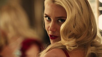 Movie still from “Machete Kills” (2013), directed by Robert Rodriguez – A woman with blonde hair and blue eyes looking at the camera; Close Up shot, Over the shoulder angle