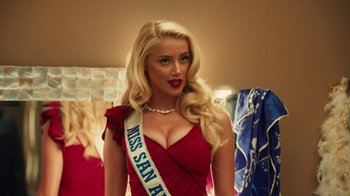 Movie still from “Machete Kills” (2013), directed by Robert Rodriguez – A woman in a red dress is posing for a picture; Close Up shot, Over the shoulder angle