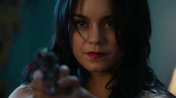Movie still from “Machete Kills” (2013), directed by Robert Rodriguez – A beautiful young lady holding a cell phone in her hand; Close Up shot, Over the shoulder angle