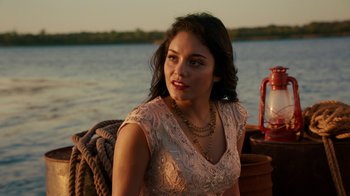 Movie still from “Machete Kills” (2013), directed by Robert Rodriguez – A beautiful young lady sitting on top of a boat in the water; Close Up shot, Over the shoulder angle