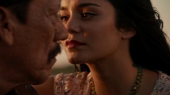 Movie still from “Machete Kills” (2013), directed by Robert Rodriguez – A woman's face and a man's face; Close Up shot, Over the shoulder angle