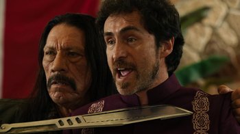 Movie still from “Machete Kills” (2013), directed by Robert Rodriguez – A man with a beard and mustache holding a large knife; Close Up shot, Over the shoulder angle