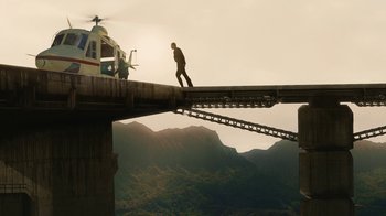Movie still from “Machete Kills” (2013), directed by Robert Rodriguez – A man walking across a bridge with a helicopter on top of it; Extreme Wide shot, Low angle