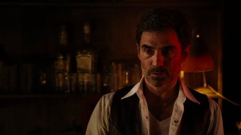 Movie still from “Machete Kills” (2013), directed by Robert Rodriguez – A person wearing a shirt and tie; Close Up shot, Over the shoulder angle