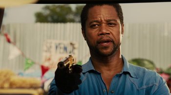 Movie still from “Machete Kills” (2013), directed by Robert Rodriguez – A man holding a gun while wearing a blue shirt; Close Up shot, Over the shoulder angle