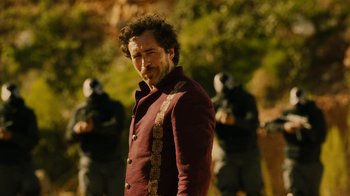 Movie still from “Machete Kills” (2013), directed by Robert Rodriguez – A man standing in front of a group of soldiers; Medium shot, Over the shoulder angle