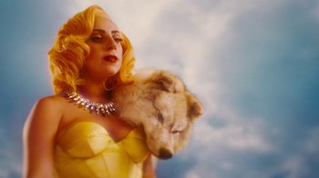 Movie still from “Machete Kills” (2013), directed by Robert Rodriguez – A woman in a yellow dress holding a white dog; Close Up shot, Overhead angle