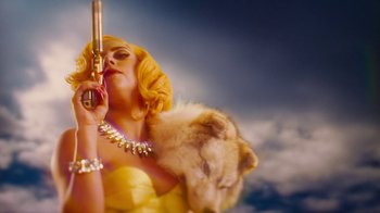 Movie still from “Machete Kills” (2013), directed by Robert Rodriguez – A woman in a yellow dress holding a gun and a dog; Medium shot, Overhead angle