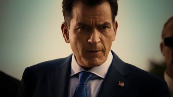 Movie still from “Machete Kills” (2013), directed by Robert Rodriguez – A person wearing a suit and tie; Close Up shot, Low angle