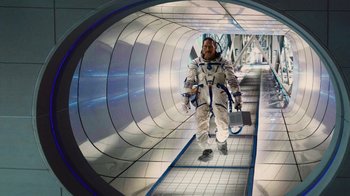 Movie still from “Machete Kills” (2013), directed by Robert Rodriguez – A man in a spacesuit is walking down a tunnel; Wide shot, Overhead angle