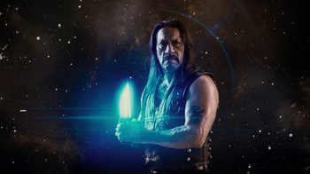 Movie still from “Machete Kills” (2013), directed by Robert Rodriguez – A man with long black hair holding a blue object; Medium shot, Low angle