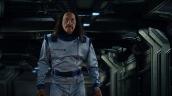 Movie still from “Machete Kills” (2013), directed by Robert Rodriguez – A man with long black hair and a long mustache; Medium shot, Low angle