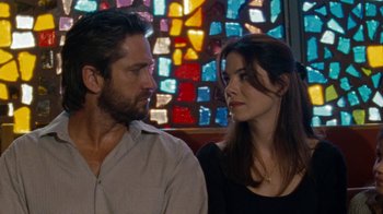 Movie still from “Machine Gun Preacher” (2011), directed by Marc Forster – A man and a woman standing next to each other in front of a stained glass window; Close Up shot, Over the shoulder angle