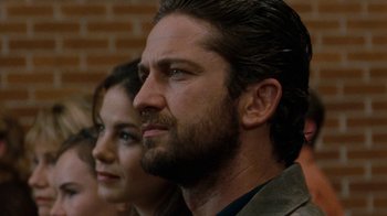 Movie still from “Machine Gun Preacher” (2011), directed by Marc Forster – A man and a woman are looking into the distance; Close Up shot, Over the shoulder angle