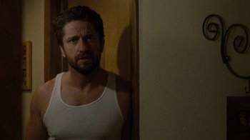 Movie still from “Machine Gun Preacher” (2011), directed by Marc Forster – A person wearing a tank top; Close Up shot, Over the shoulder angle