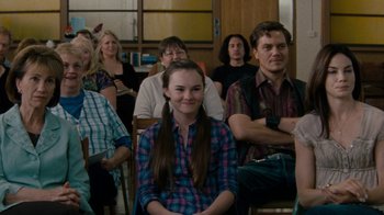 Movie still from “Machine Gun Preacher” (2011), directed by Marc Forster – A group of people sitting and standing in a room; Medium shot, Over the shoulder angle