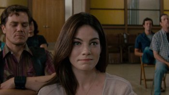 Movie still from “Machine Gun Preacher” (2011), directed by Marc Forster – A person with long brown hair; Close Up shot, Over the shoulder angle